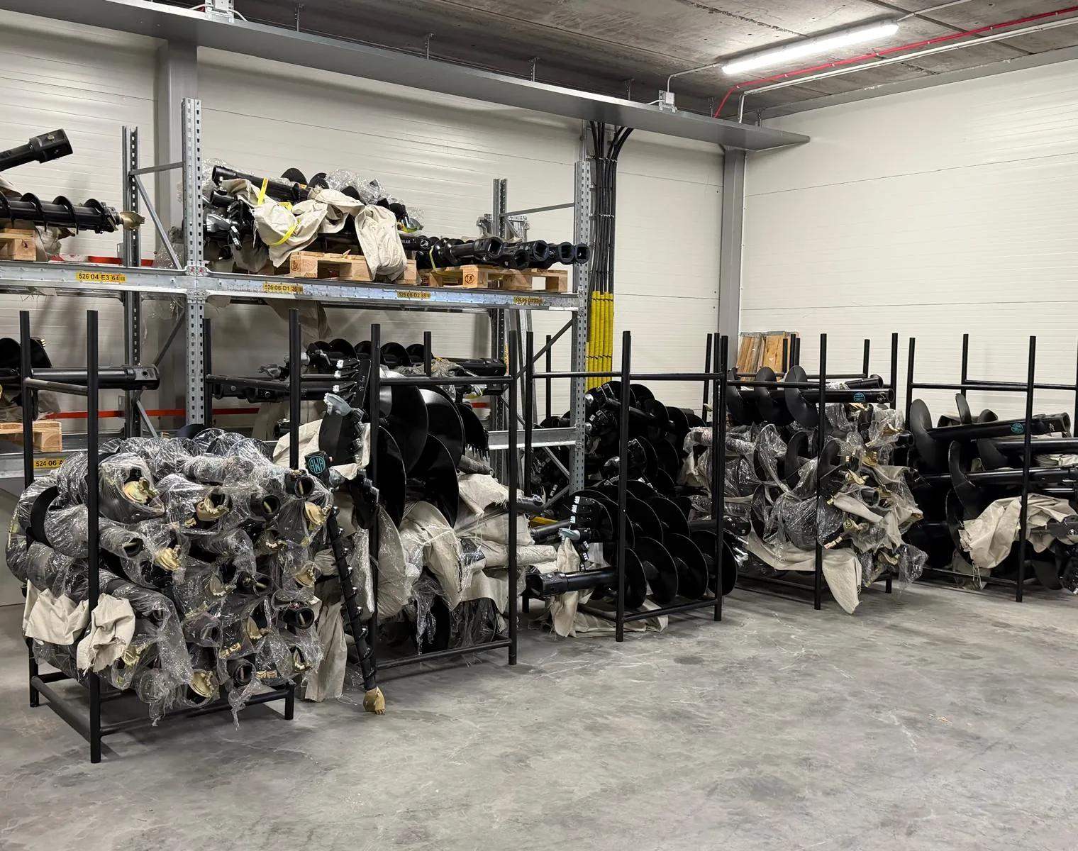 Rows of earth augers on racks and pallets in our warehouse in Saltsjö-Boo