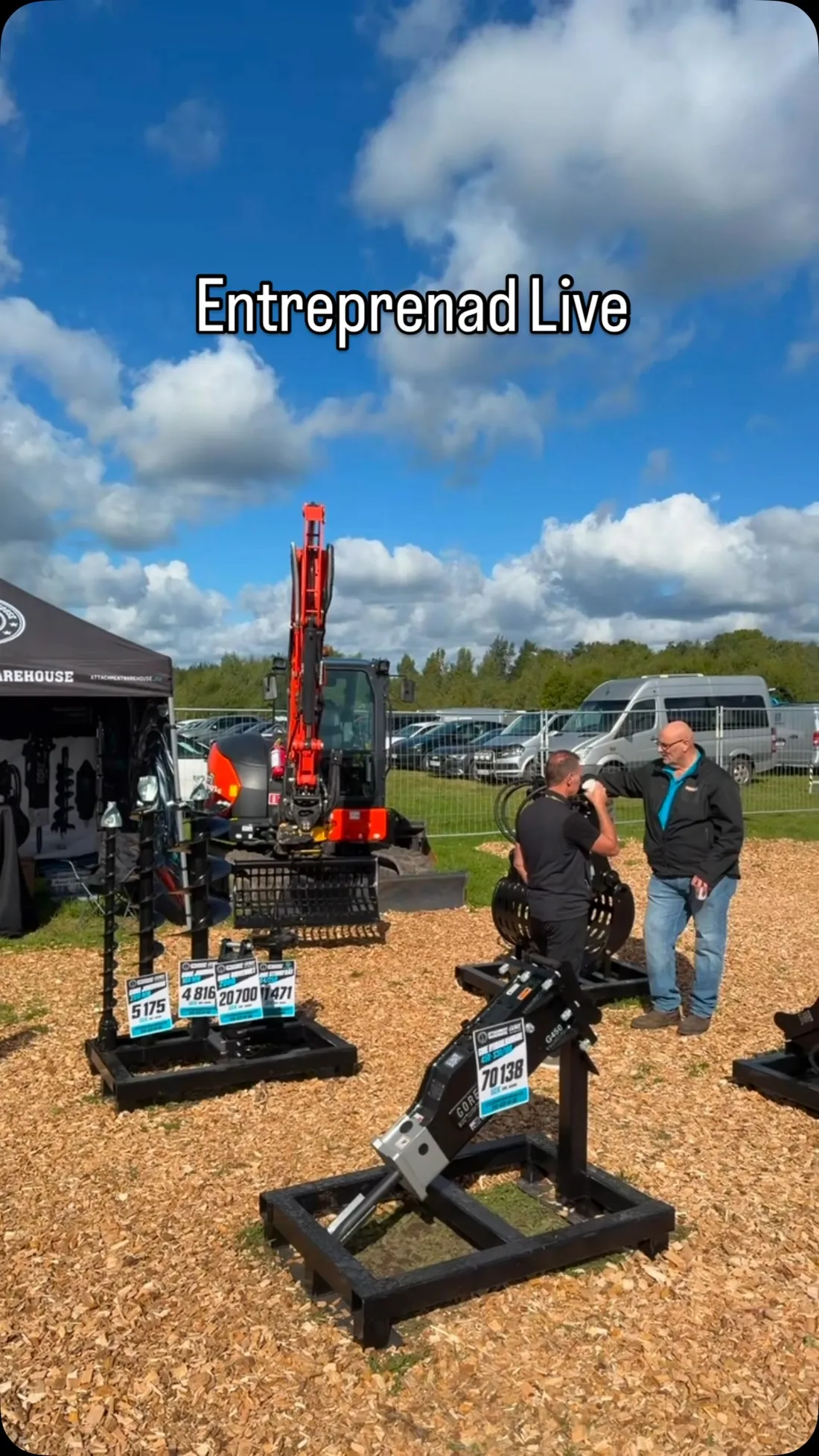 Attachment Warehouse stand at Entreprenad Live 2026 with an excavator, attachments on frames and visitors talking