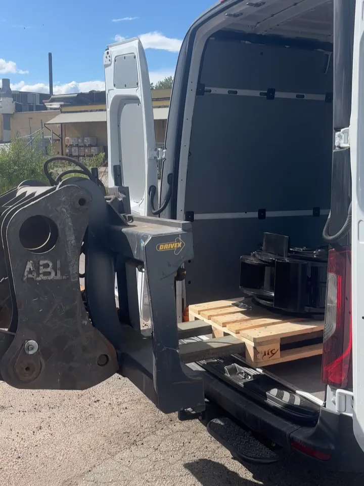 Van with open rear doors and attachments on a pallet in the load space